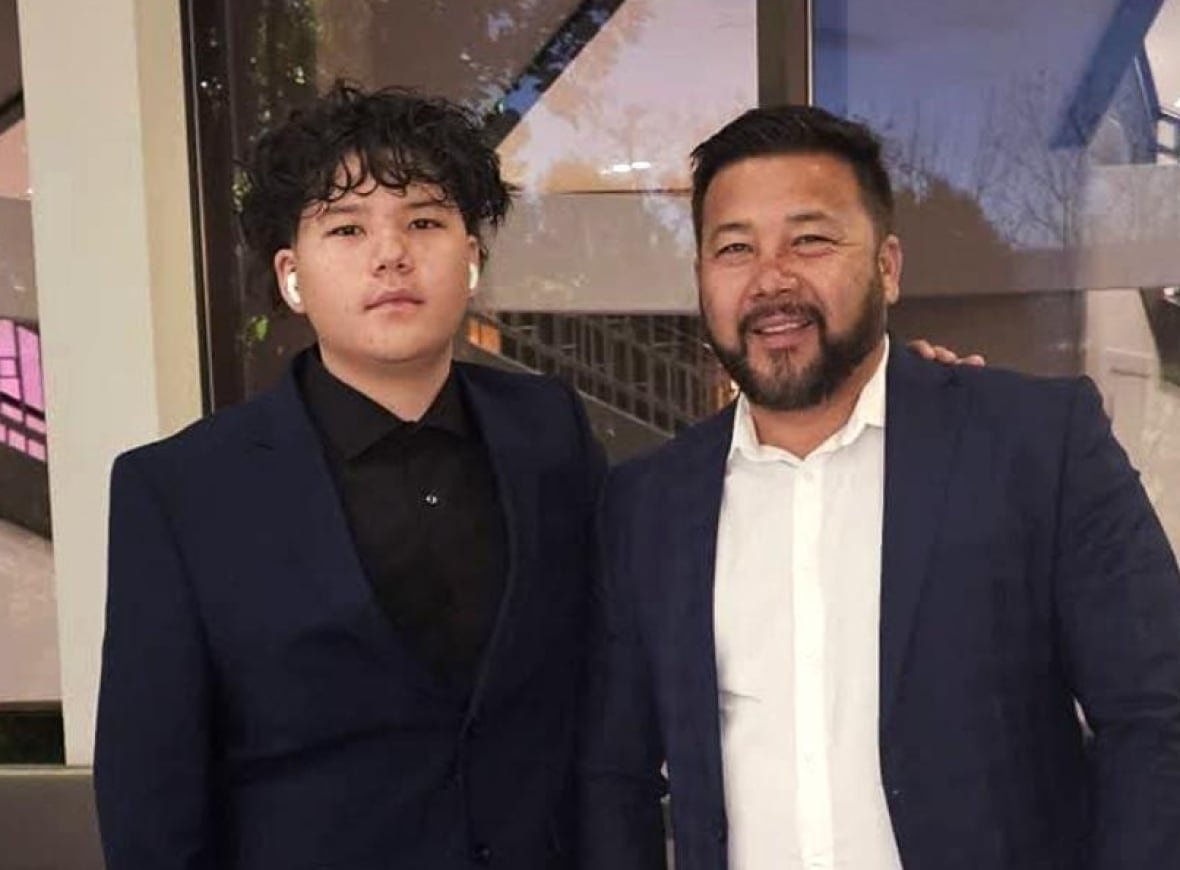 two people in suits smiling