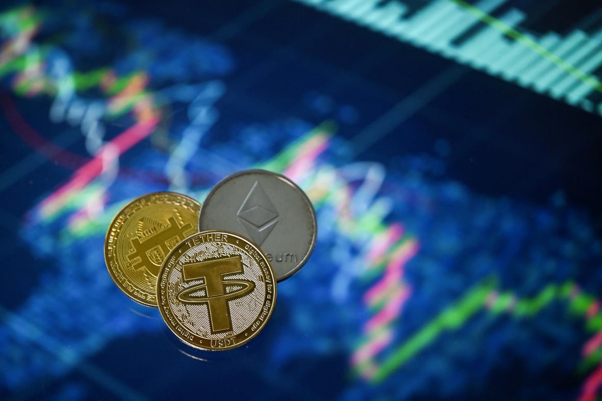 Three coins - one gold, another silver-and-gold, and one completely silver - are grouped together.