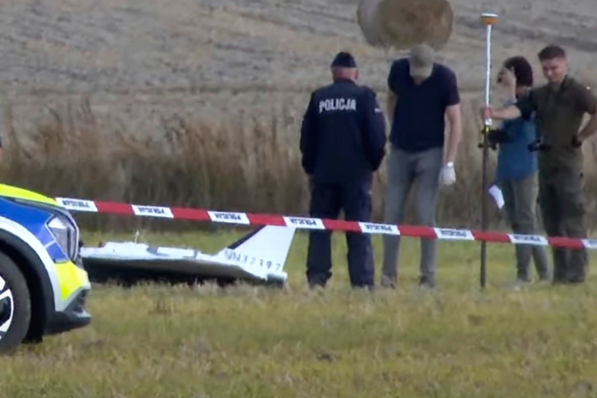 In this image made from video, Police and Military Police secure parts of a damaged object shot down by Polish authorities at a site in Wohyn, Poland, Wednesday, Sept. 10, 2025.