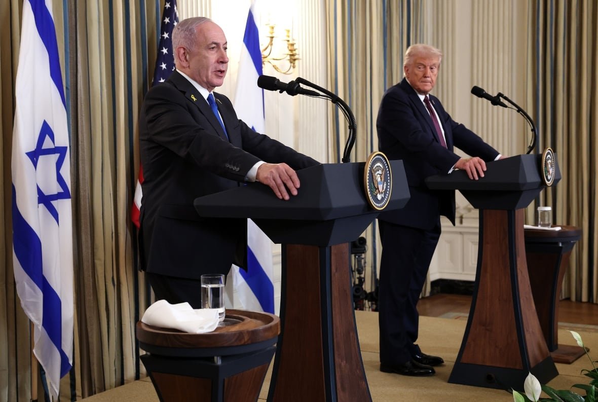 Two men in suits stand at wooden podiums with the presidential seal. They are flanked by Israeli flags.