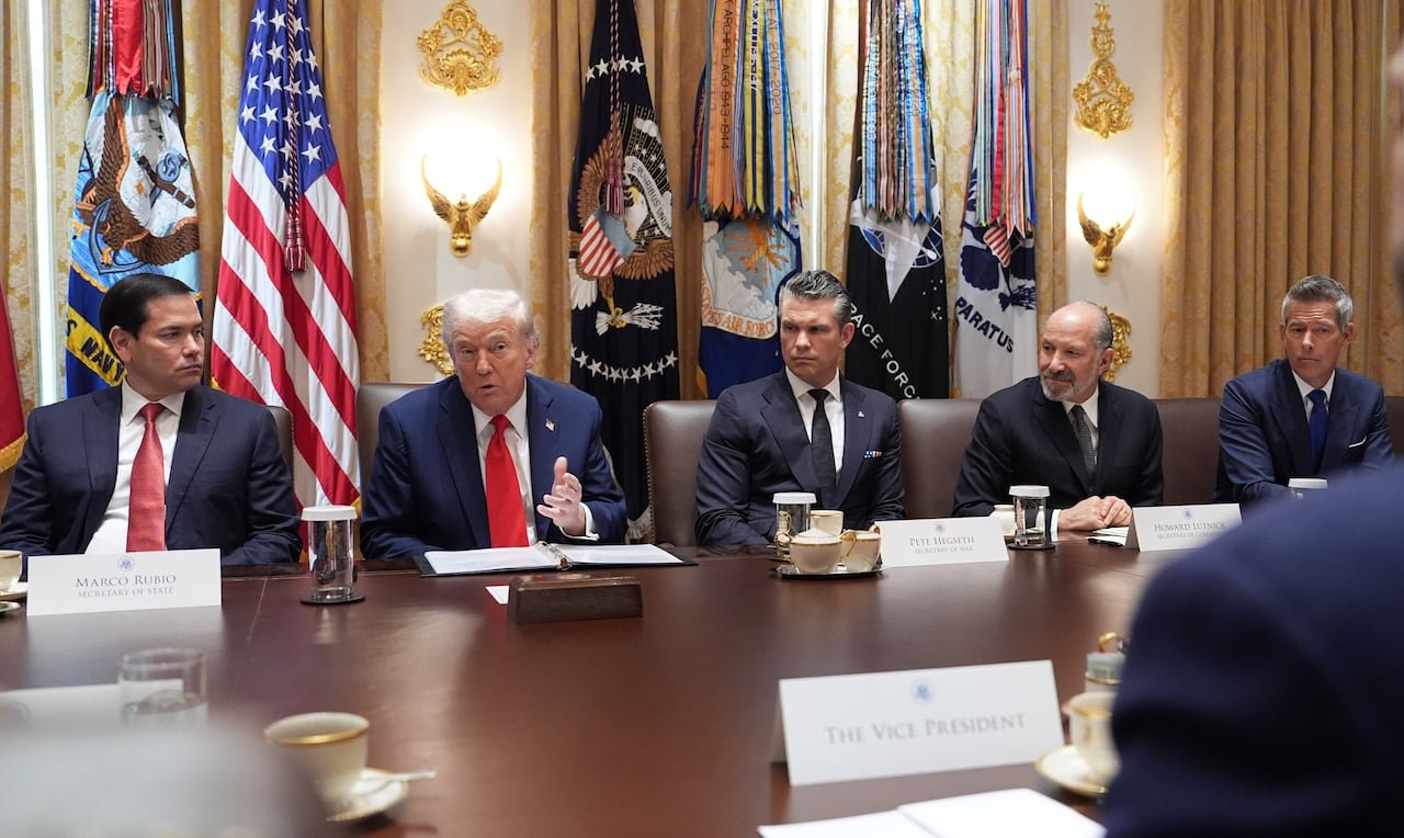Seated at a table from left to right: Marco Rubio, Donald Trump, Pete Hegseth, Howard Lutnick and Sean Duffy.