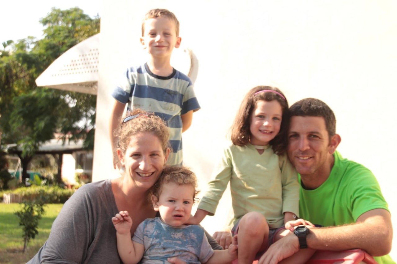 A family of five poses for a photo.