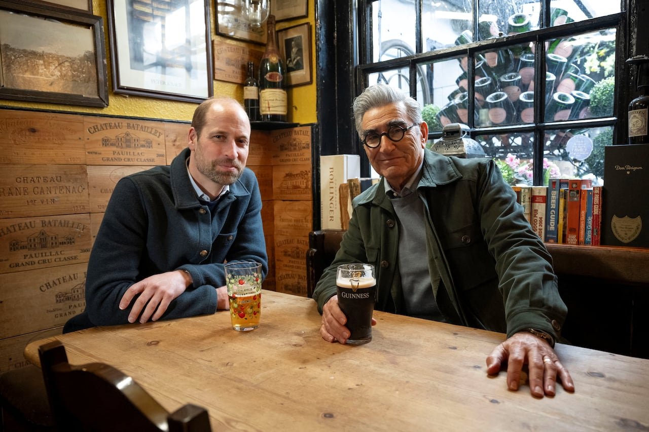 Two people sit at a table in a pub.