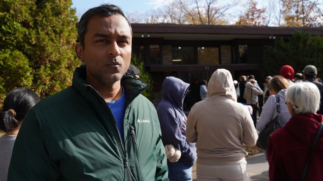 Man stands in a line with hundreds of people