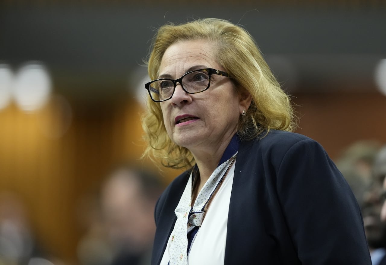 A minister of immigration stands at Parliament Hill's house during question period.