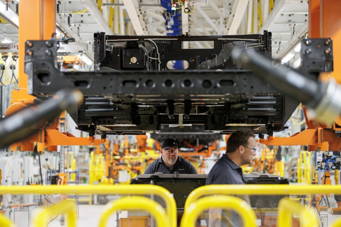 Workers take part in a grand-opening event at General Motors’s CAMI EV plant, in Ingersoll, Ont.