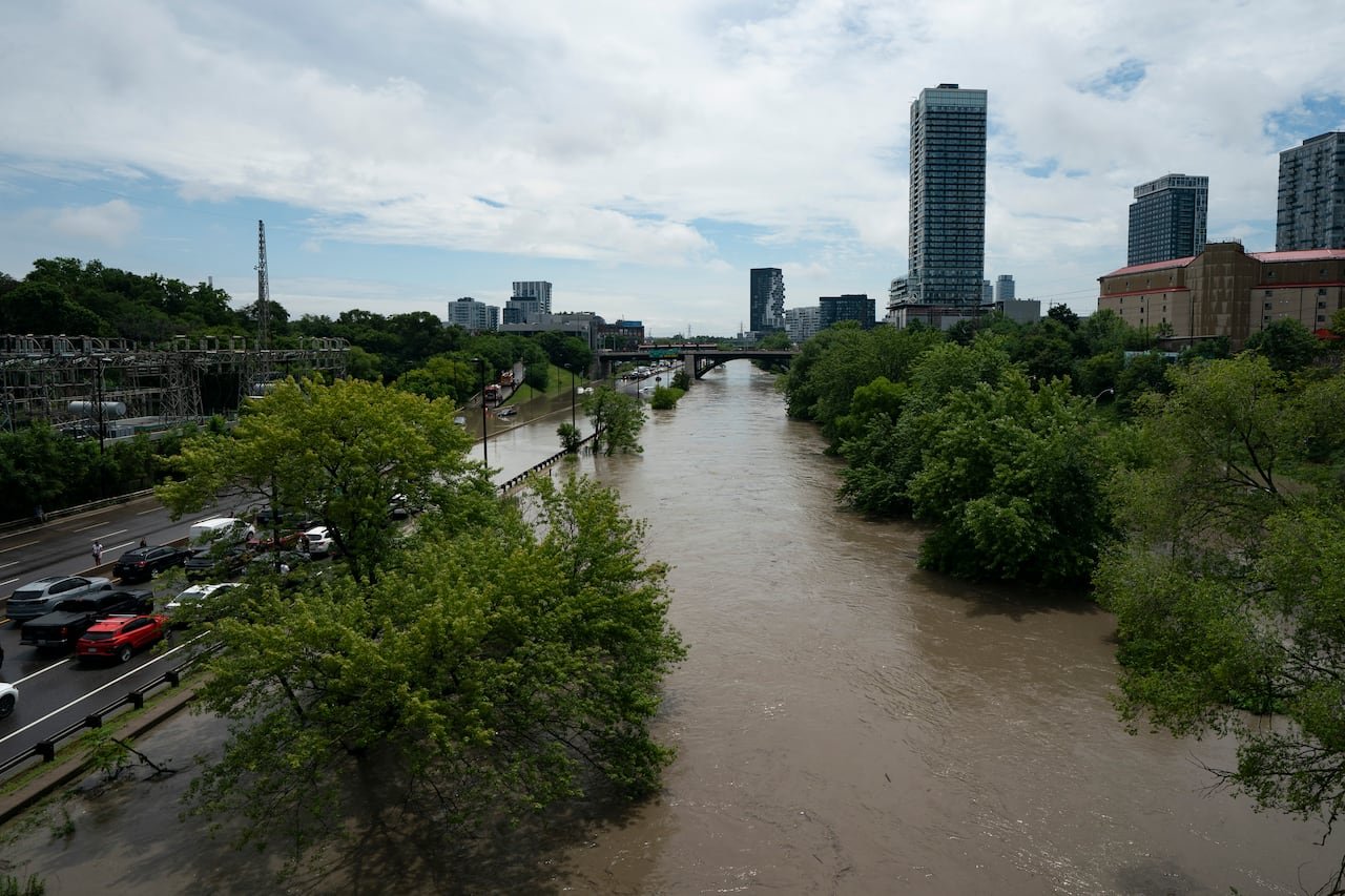 The Don River overflows causing flooding surrounding on roads.