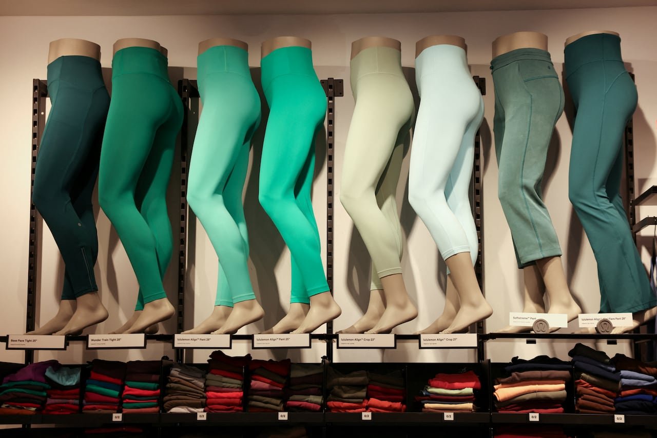 various fits of green lululemon pants are displayed on mannequins in a store