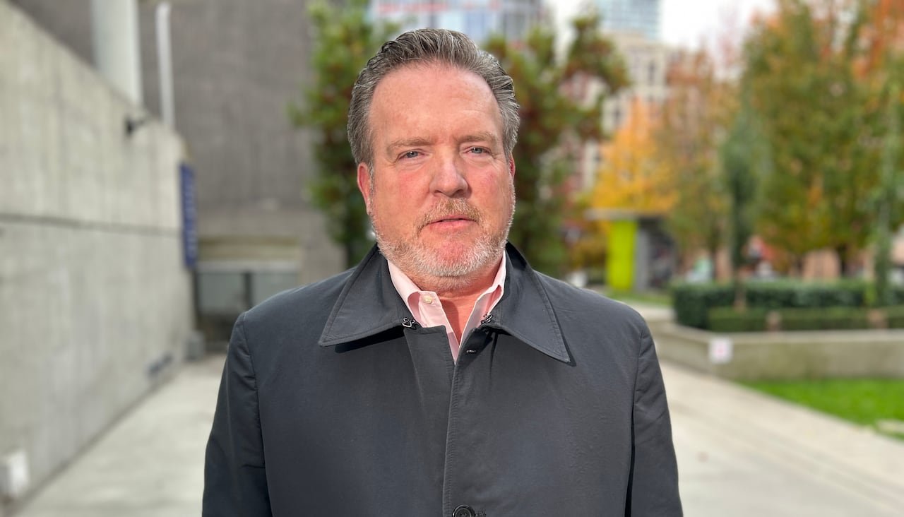 Len Saunders standing outside. 