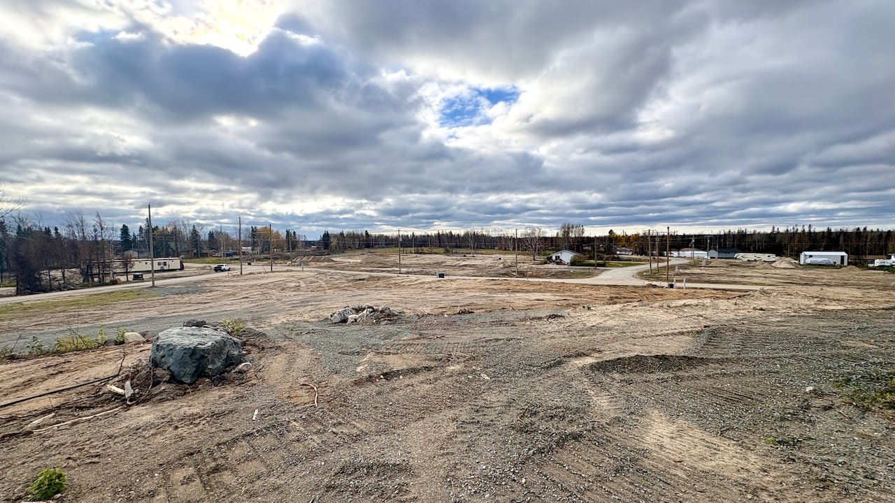 A landscape picture of empty residential lots in a lakeside community.